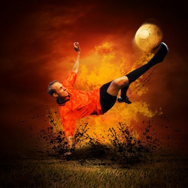 Football player in fires flame on the outdoors field - 900113639