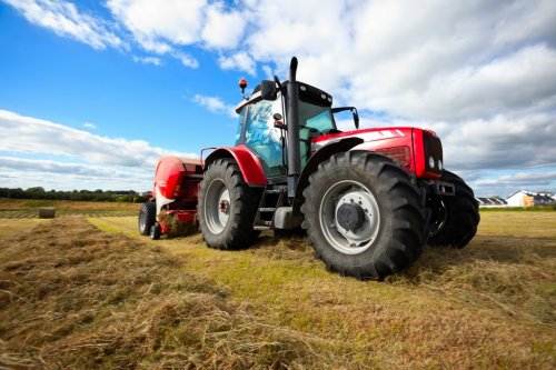 tractor collecting haystack in the field - 900142887
