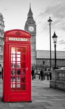 Red phone booth in London with the Big Ben in black and white