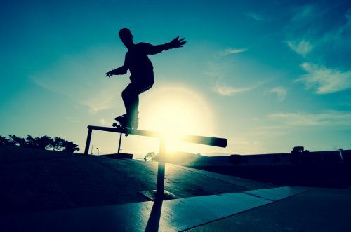 Skateboarder silhouette on a grind - 900306324