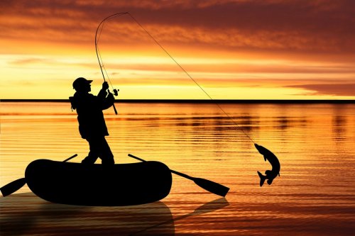 Fishermen in boat at sunset - 900417705