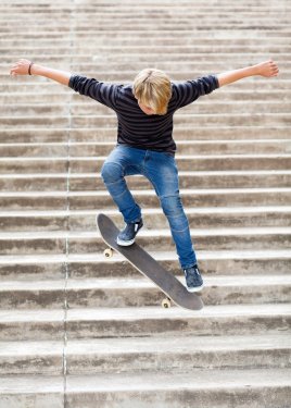 teen boy skateboarding on stairs