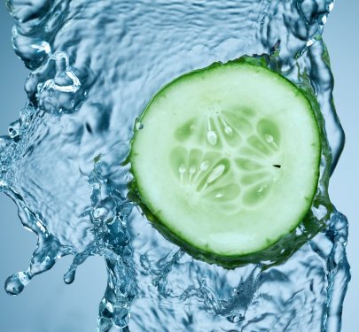 cucumber in spray of water. - 900636372