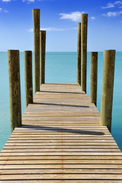 Wooden jetty leading into a turquoise sea in Governor's Harbour