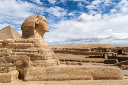 Great Sphinx of Giza under a cloudy blue sky