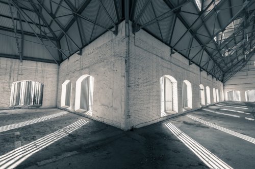 an empty desolate industrial building inside - 901144025