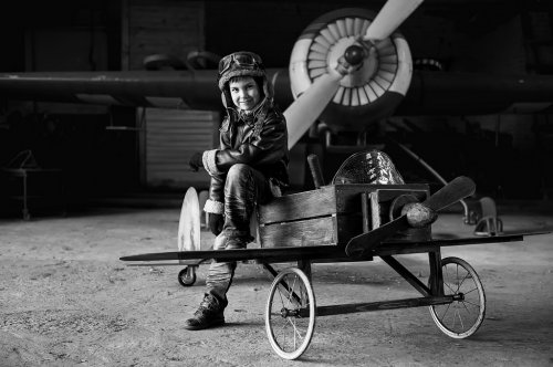 Young Aviator in aircraft in a hangar - 901144113