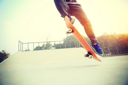 skateboarding legs  jumping at skatepark - 901144413