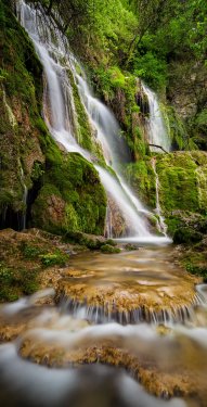 Beautiful waterfall among cliffs in spring time - 901144634
