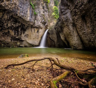 Spring view of a beautiful waterfall among cliffs - 901144641