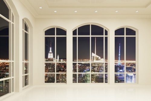 White loft interior with big windows and city view at night