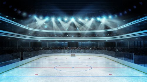 hockey stadium with spectators and an empty ice...