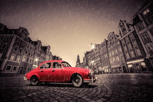 Retro red car on cobblestone historic old town in rain. Wroclaw, Poland. - 901146471