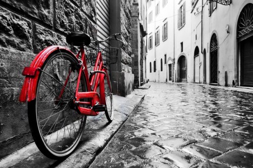 Retro vintage red bike on cobblestone street in the old town. Color in black ... - 901146632