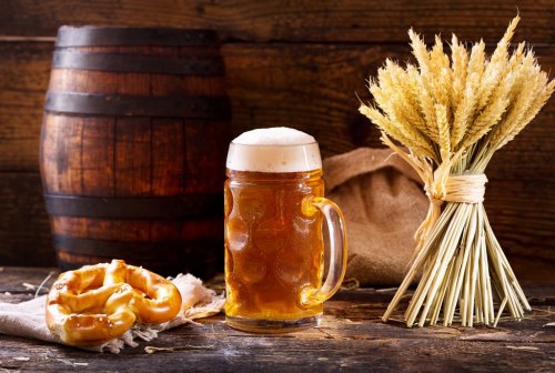 mug of beer with wheat ears and pretzel