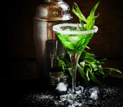 Green cocktail with tarragon and ice in martini glass on dark ba - 901147340