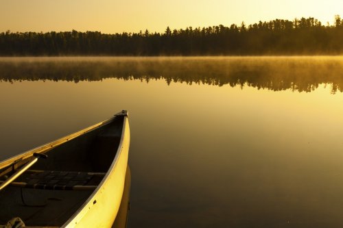 Canoe overlooking foggy sunrise - horizontal  - 901147853