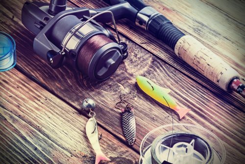 fishing tackle on a wooden table - 901148235