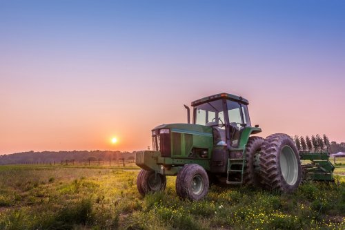 Tractor in a field on a Maryland farm at sunset - 901148831