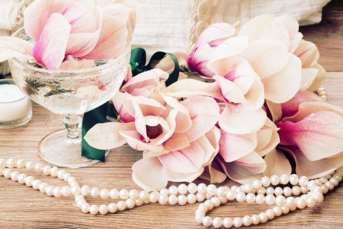magnolia flowers with pearls on wooden table - 901148980