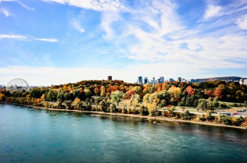 Autumn over Montreal downtown from St-Laurence river panorama with blue sky a... - 901149910
