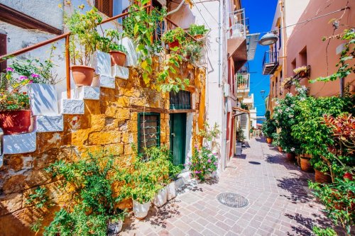 Pictoresque mediterranean street with stairs and flower pots, Chania, island ... - 901150560