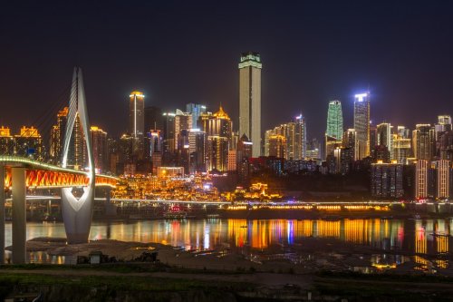 River And Illuminated Modern Buildings Against Sky at night in city of China.
