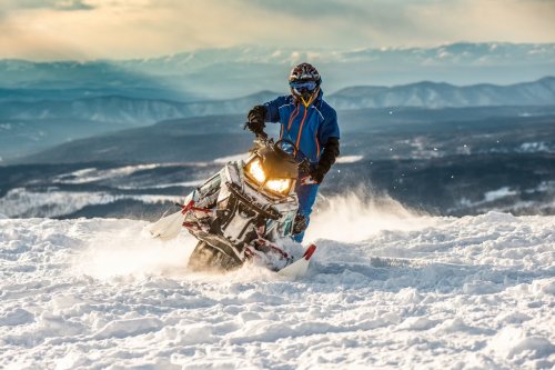 Rider on the snowmobile in the mountains. active drive - 901151605