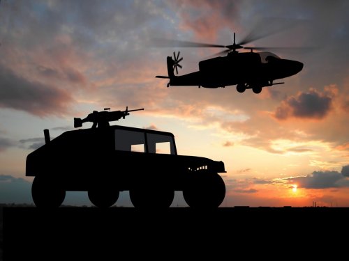 Silhouette of truck over sunset with helicopter. - 901153162