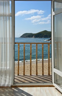 View through an open door of the sea sunny summer day. - 901154187
