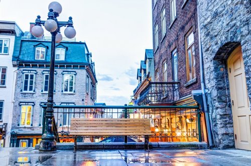 Empty bench during blue hour by lower old town street called Rue du Petit Champlain on Escalier Casse-Cou