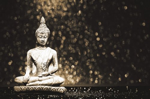 Buddha statue on a bright shiny background with bokeh. Photo in vintage style - 901154789