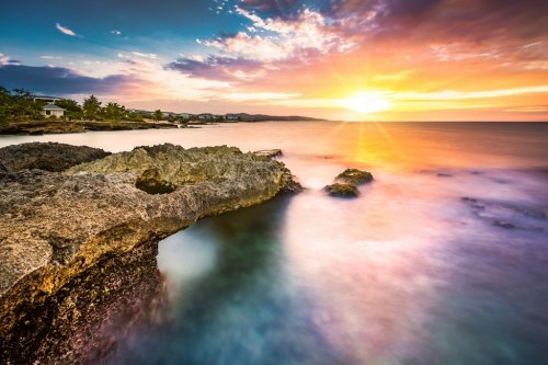 Long exposure sunset over a tropical rocky beach in Jamaica - 901155488