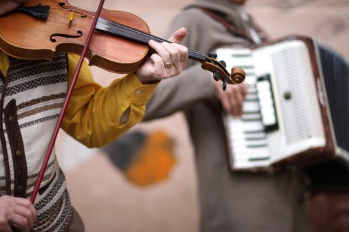 Music band performance; hands of violincellist in focus