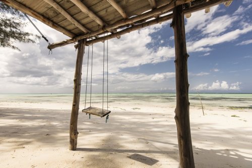 Beautiful swing with blue sky and white clouds in background, Zanzibar, Tanzania - 901156332