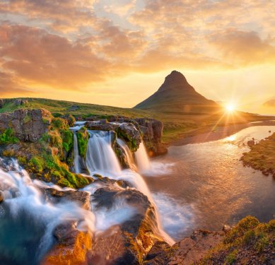 Beautiful landscape with sunrise on Kirkjufellsfoss waterfall and Kirkjufell mountain, Iceland, Europe