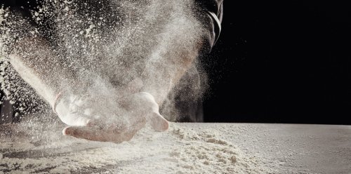 Cloud of flour caused by man cleaning off hands