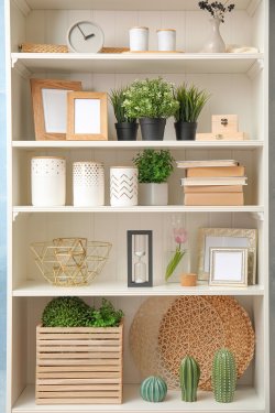 White shelving unit with plants and different decorative stuff - 901157393