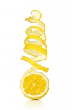 The lemon skin is twisted in a spiral with reflection on an isolated white ba... - 901157430