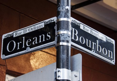 Street signs for Rue D' Orleans and Rue Bourbon in New Orleans, Louisiana - 901157611