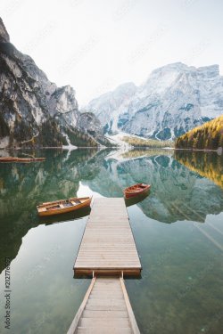 Traditional rowing boats at Lago di Braies at sunrise in fall, South Tyrol, Italy
