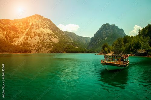 Pleasure boat and beautiful panorama of lake and mountains. - 901157846