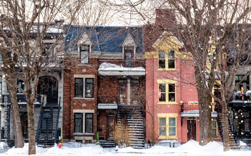 Snowfall in a Montreal street. Winter scene of traditional architecture.