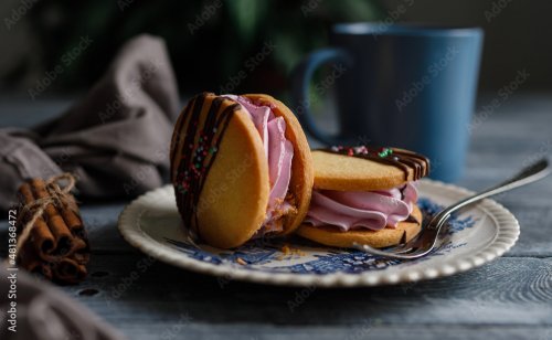 Homemade cookies sandwich with berry filling on a vintage plate. Sweet dessert. Rustic style.