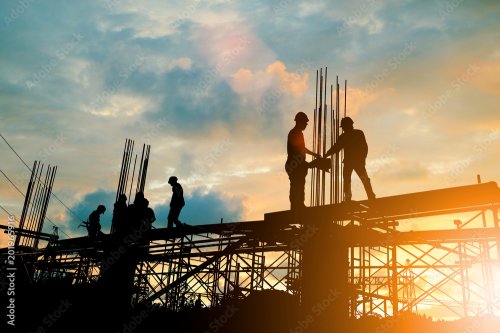 Silhouette of engineer and construction team working at site over blurred background sunset